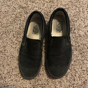 All black Vans slip-ons